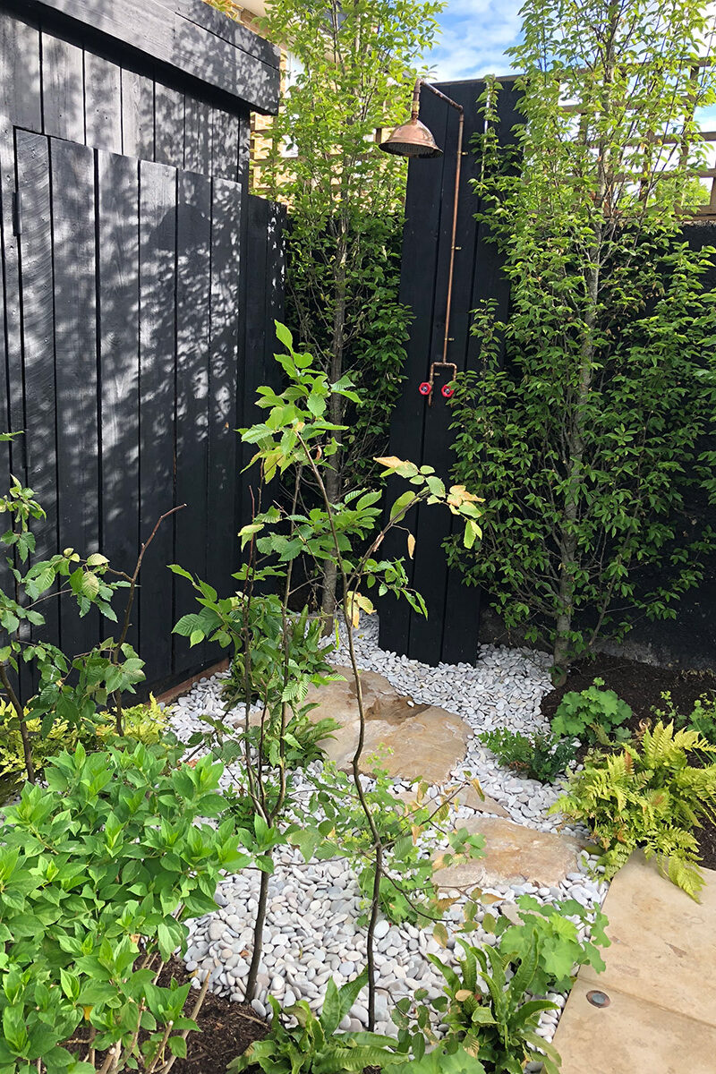 Studio Ikram Garden design with poolside shower